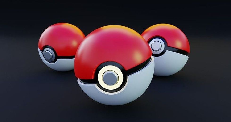 3D render of three pokeballs on dark background