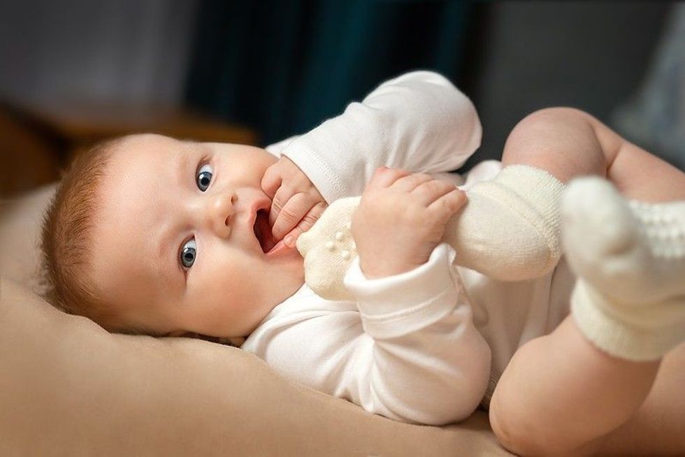 a baby is lying on the bed