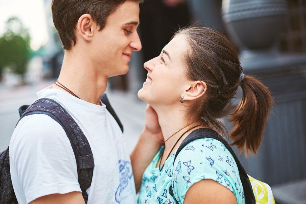 A beautiful young couple looking at each other lovingly and smiling