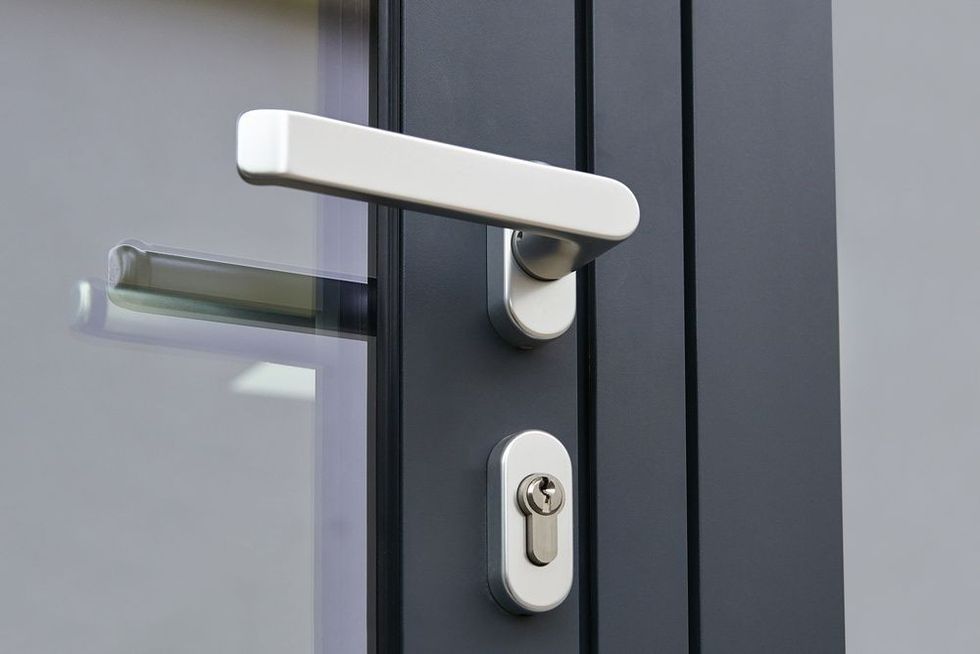 A black door with silver handle and latch
