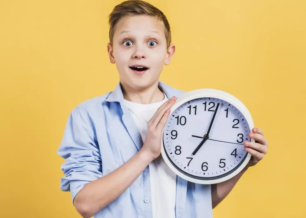 A boy holding a clock and looking surprised as his parents explain to him why the clocks go back.