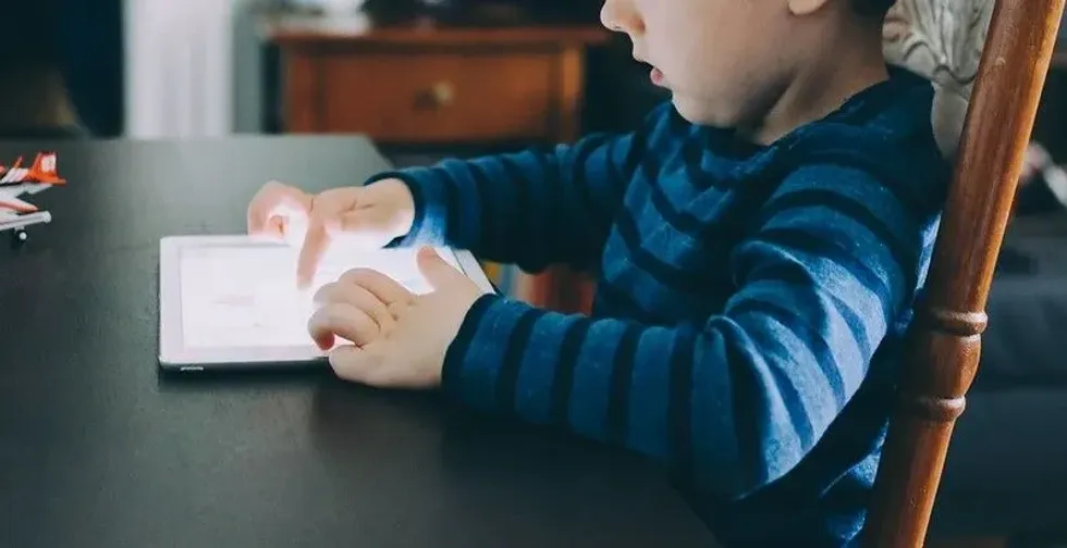 A child playing on his tablet.