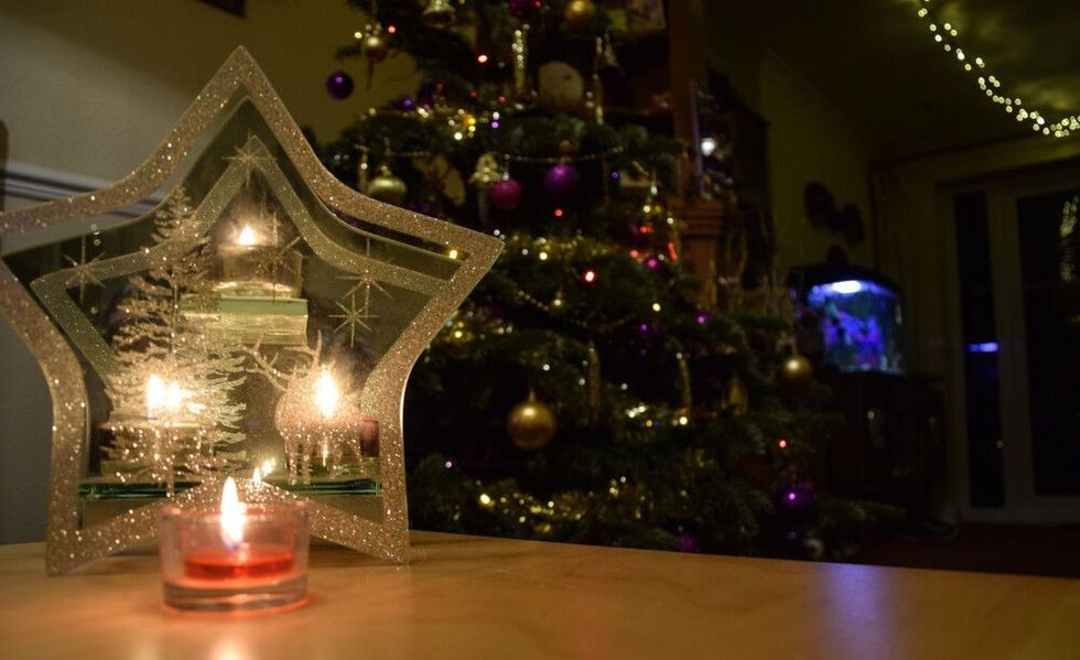 A Christmas Tree behind a decorative tea light display