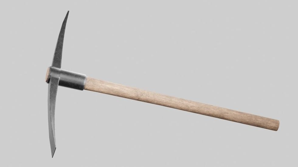 A closeup shot of a pickaxe on the gray background.