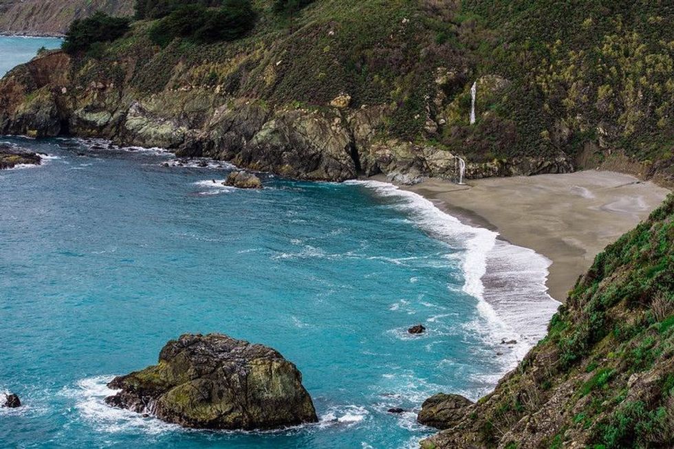 A coastal overlook with a view of dramatic waterfalls along the Pacific Coast Highway