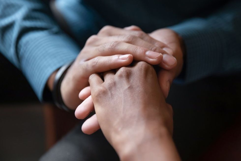 A couple holding hands in a promise or vow