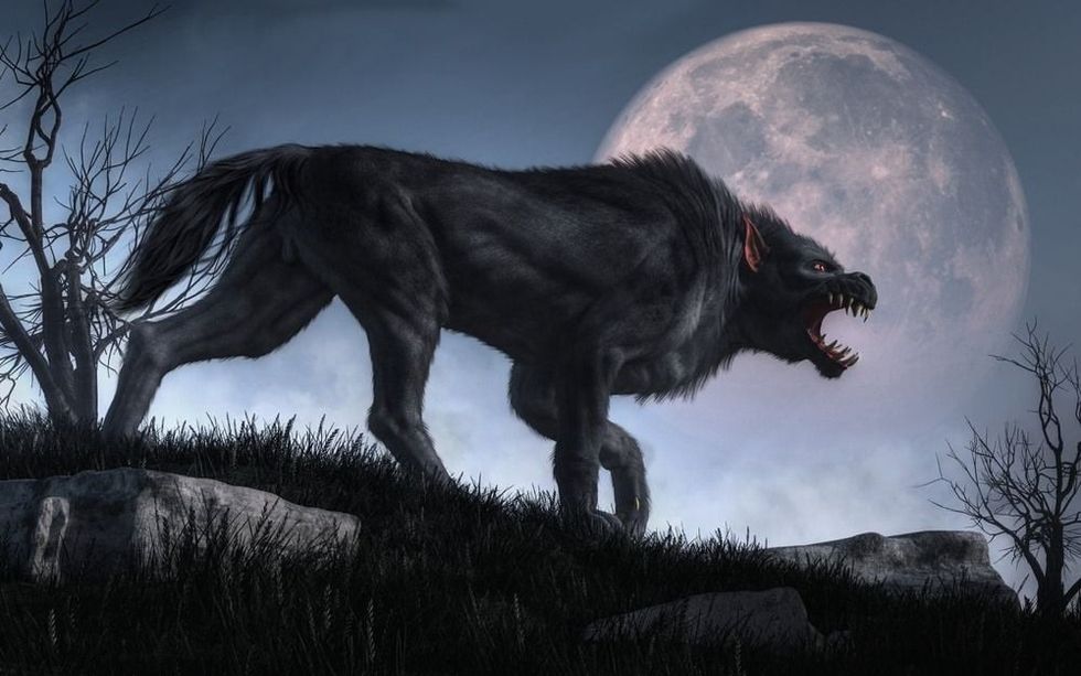 A demonic creature with big claws and teeth stalks through long grass