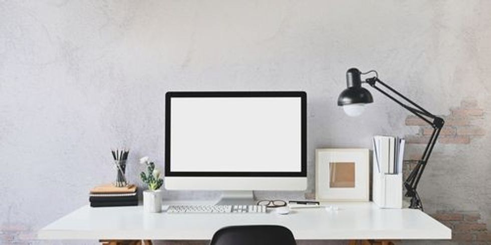 A desk with computer and other accessories