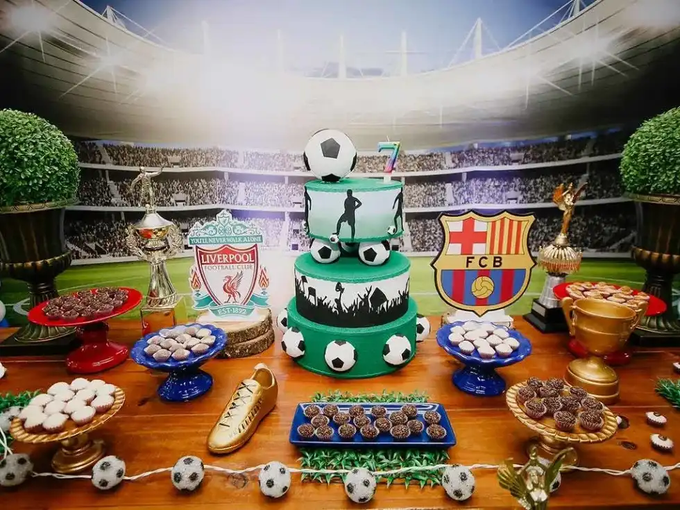 A display of cakes and snacks at a sports themed birthday party.