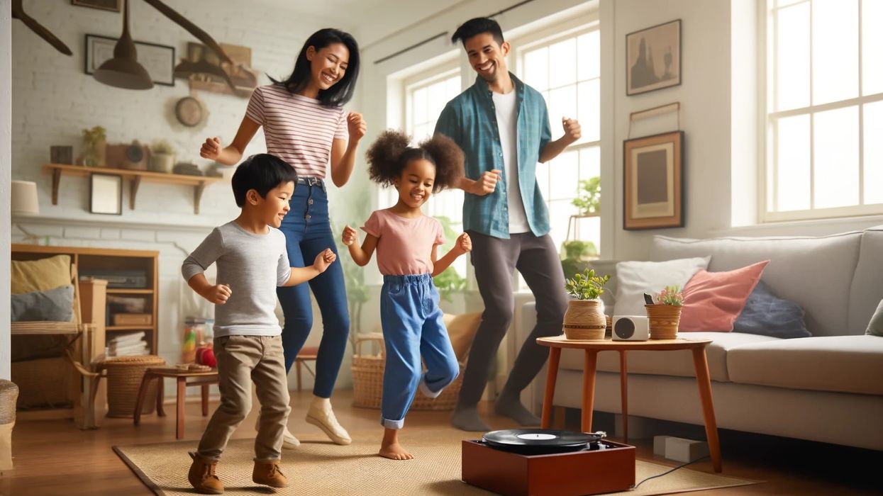 A family dancing joyfully in their cozy living room, listening to music from a record player.