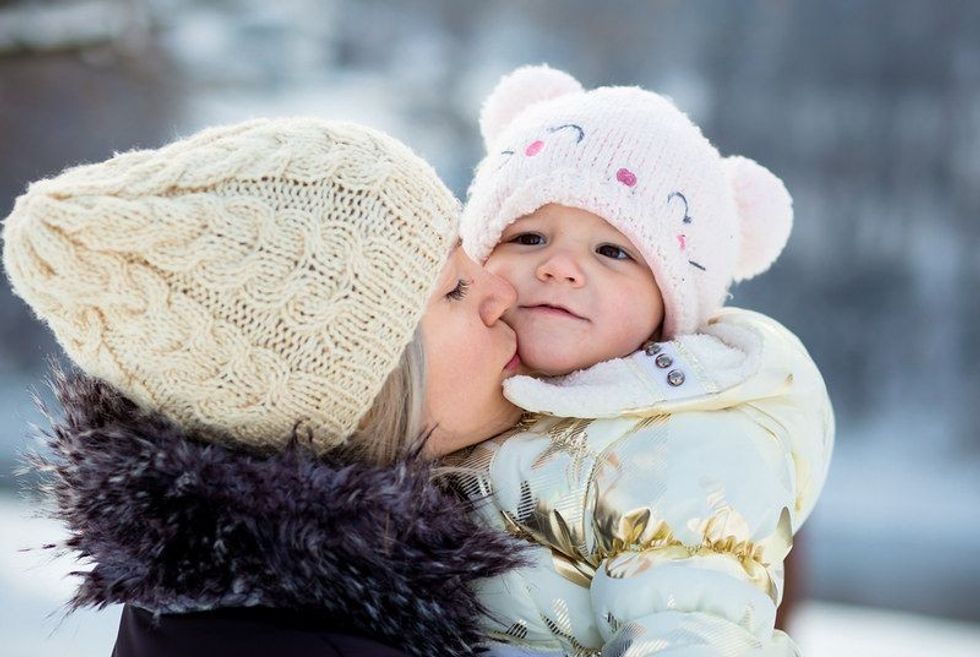 A girl and a baby wearing winter clothes