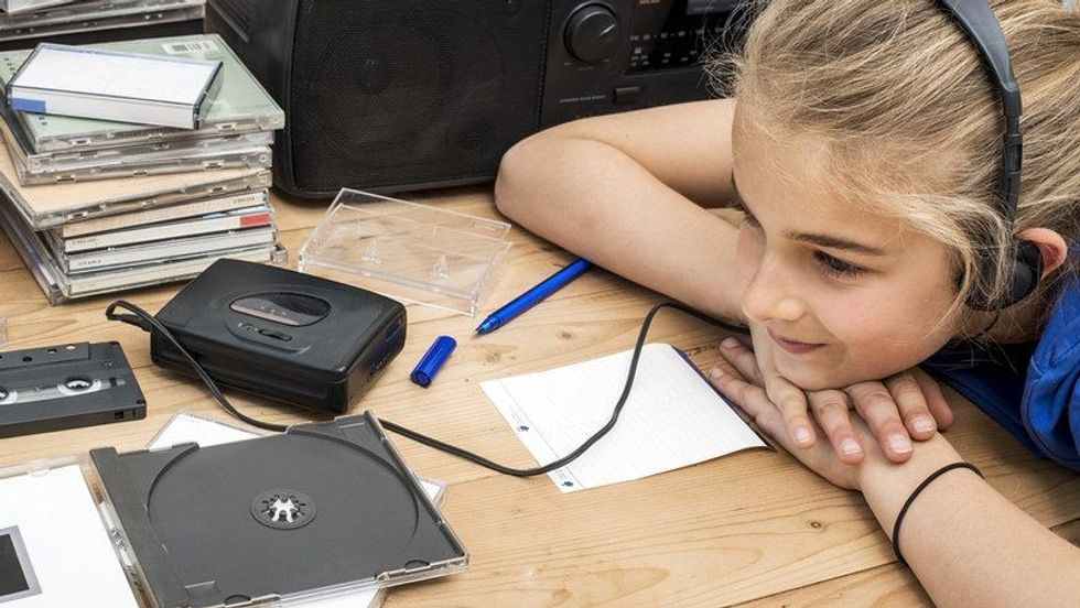 A girl listening to a audio book.