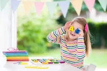 A girl playing with alphabet blocks