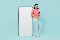 A happy woman standing next to life size mobile