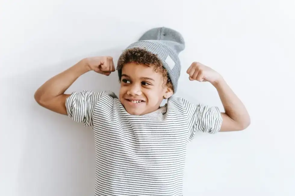 A little boy flexing his bicep muscles