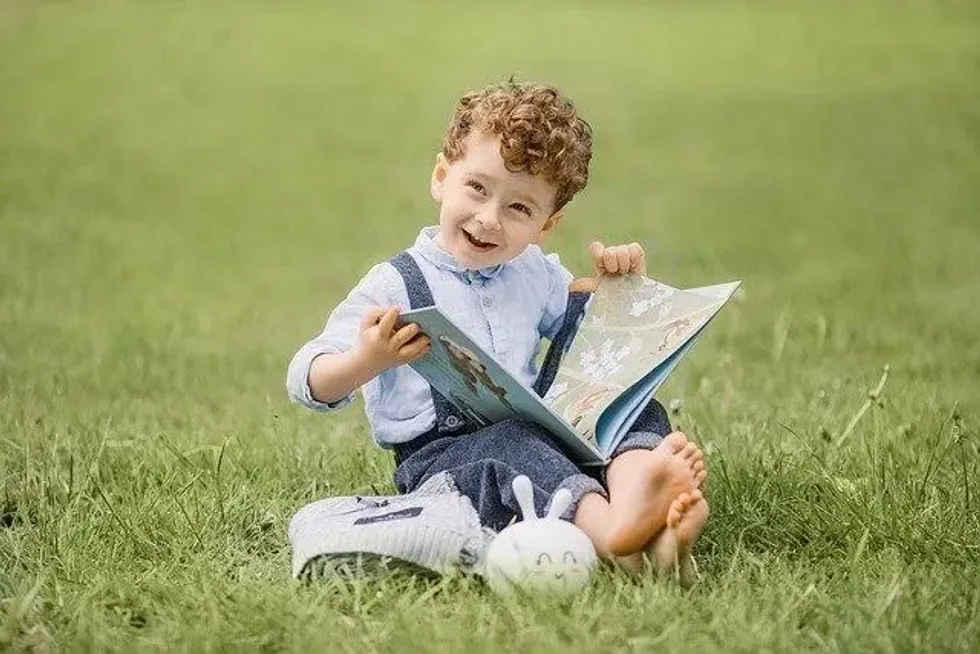A little boy reading a book 
