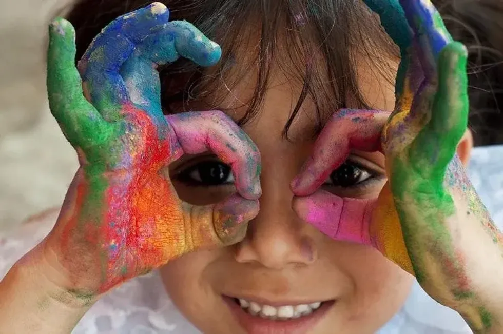 A little girl making sign with her hands of glasses on eyes