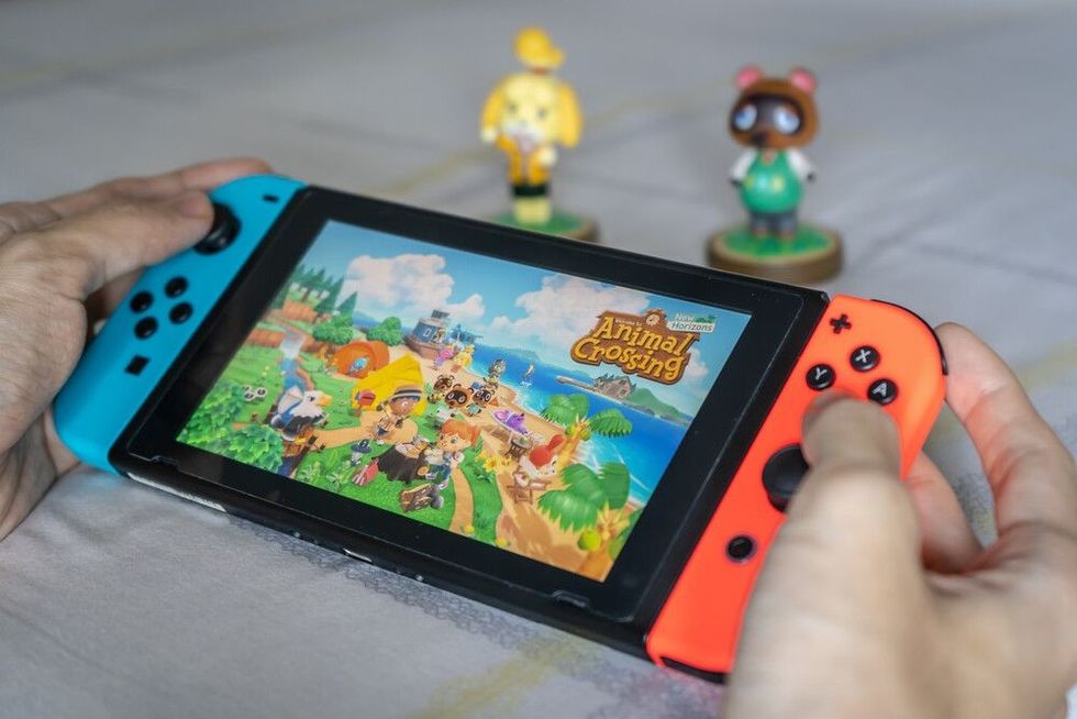 A man playing Animal Crossing on Nintendo Switch.