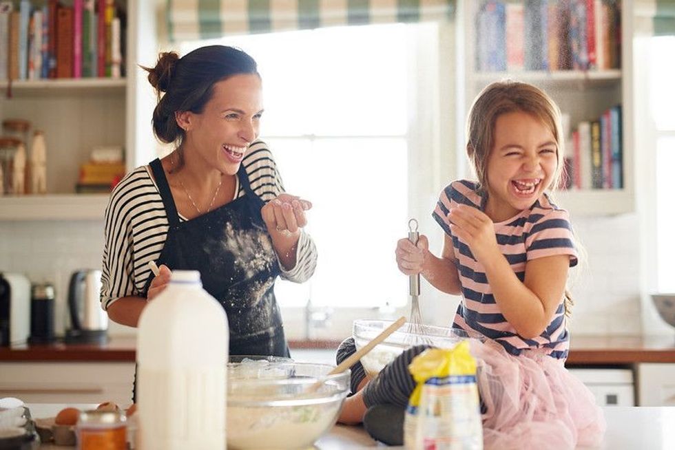 A mother and child having fun during the cooking process