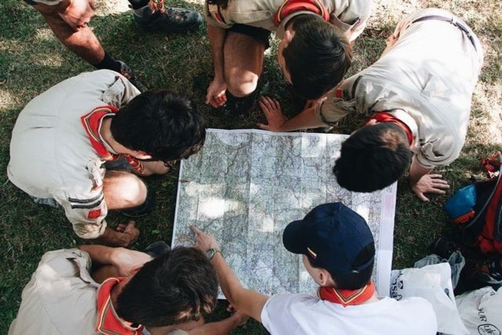 A National Boy Scout Day fact is that boy scouts are taught to do a good deed, learn survival skills and self-reliance, and can earn a merit badge for the honor.