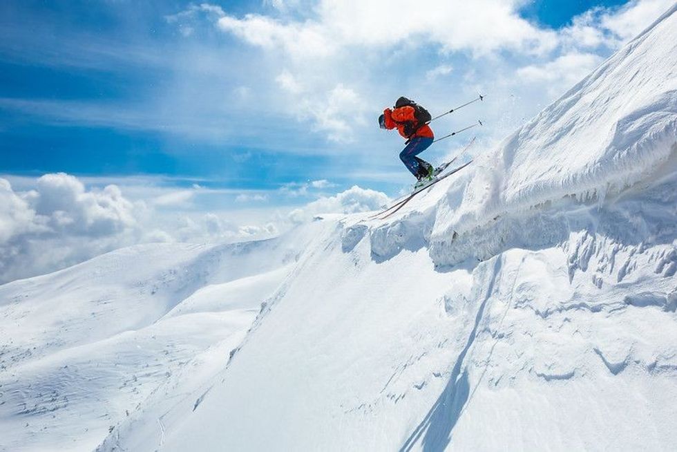 A person ski jumping on the snowy mountains of Carpathians, Ukraine