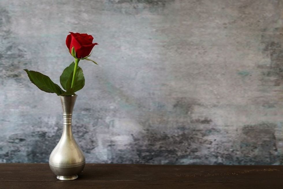A red rose in the pewter vase