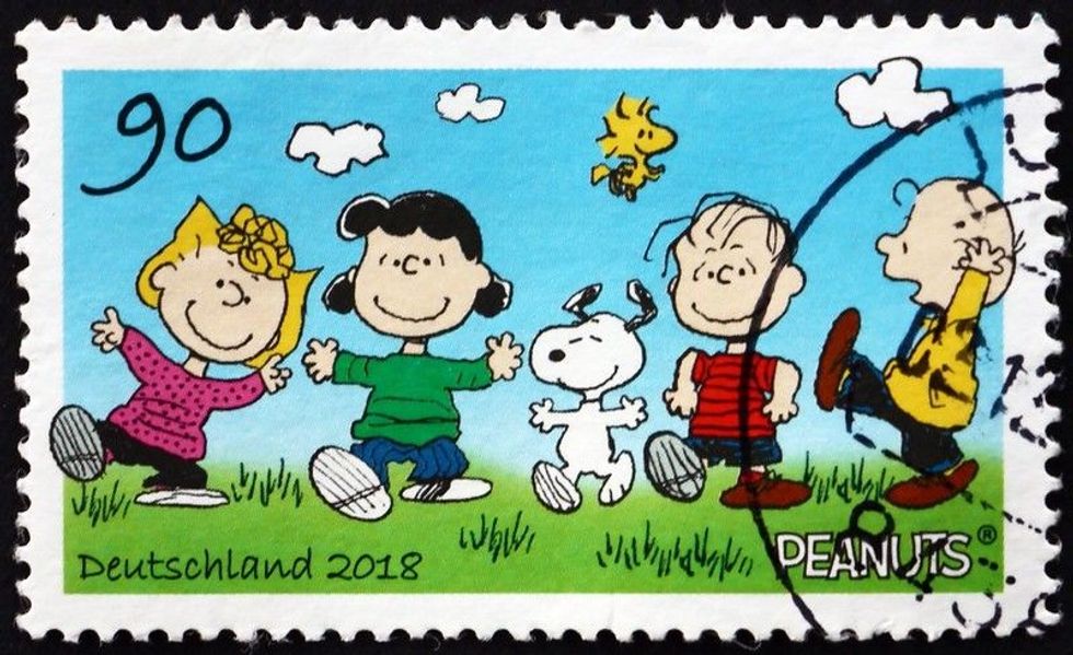 A stamp printed in Germany shows the Peanuts Gang cartoon