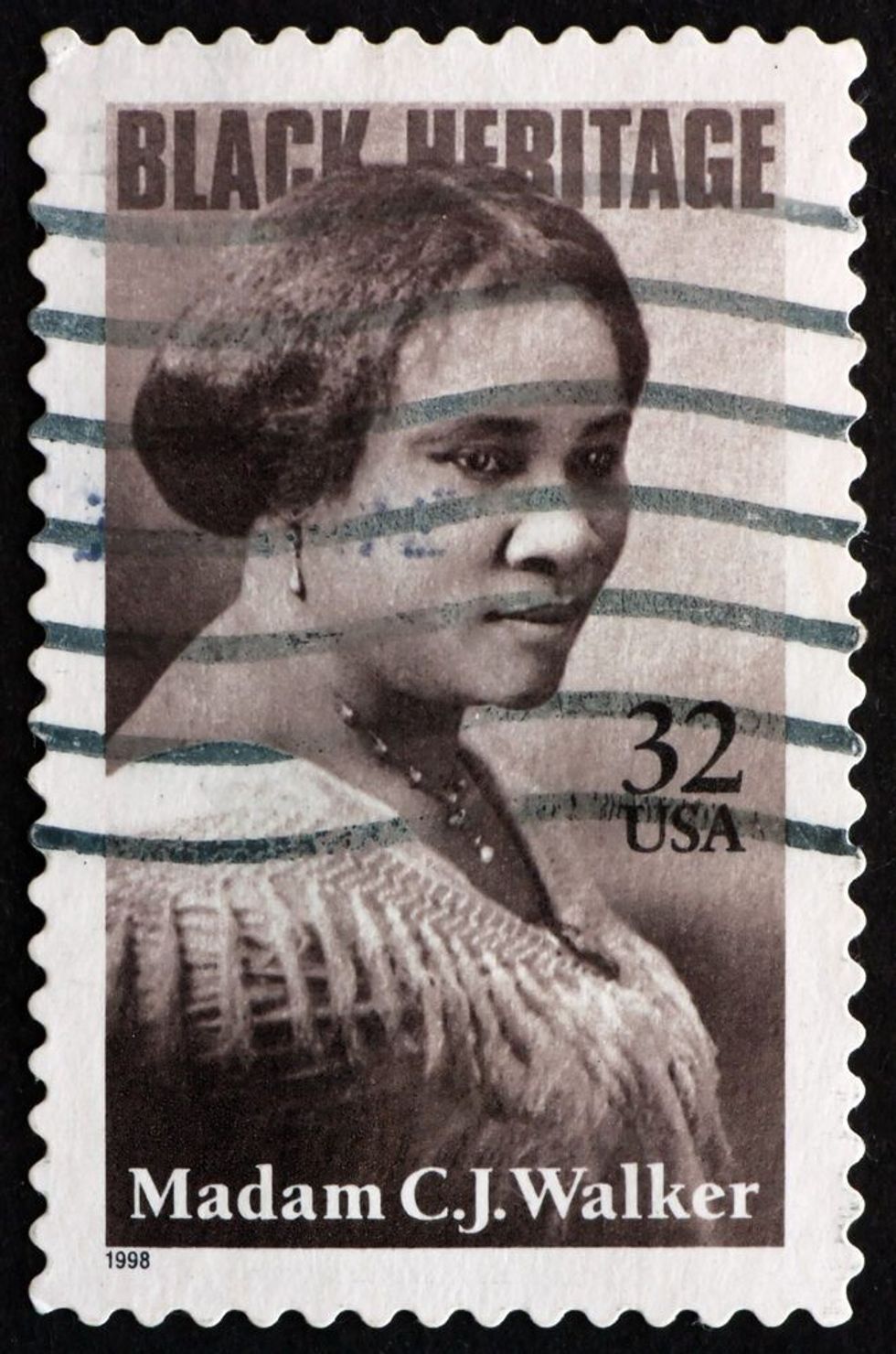a stamp printed in the USA shows Madam C. J. Walker, Entrepreneur, Philanthropist, and the First Female, self-made Millionaire in America, Black Heritage, circa 1998