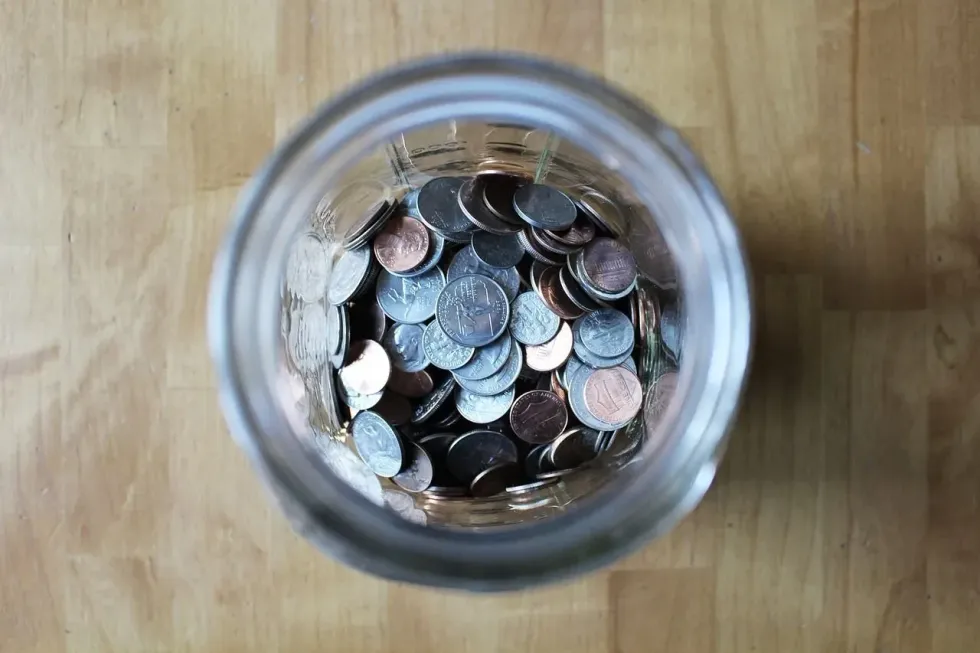 A stash of coin in a jar.
