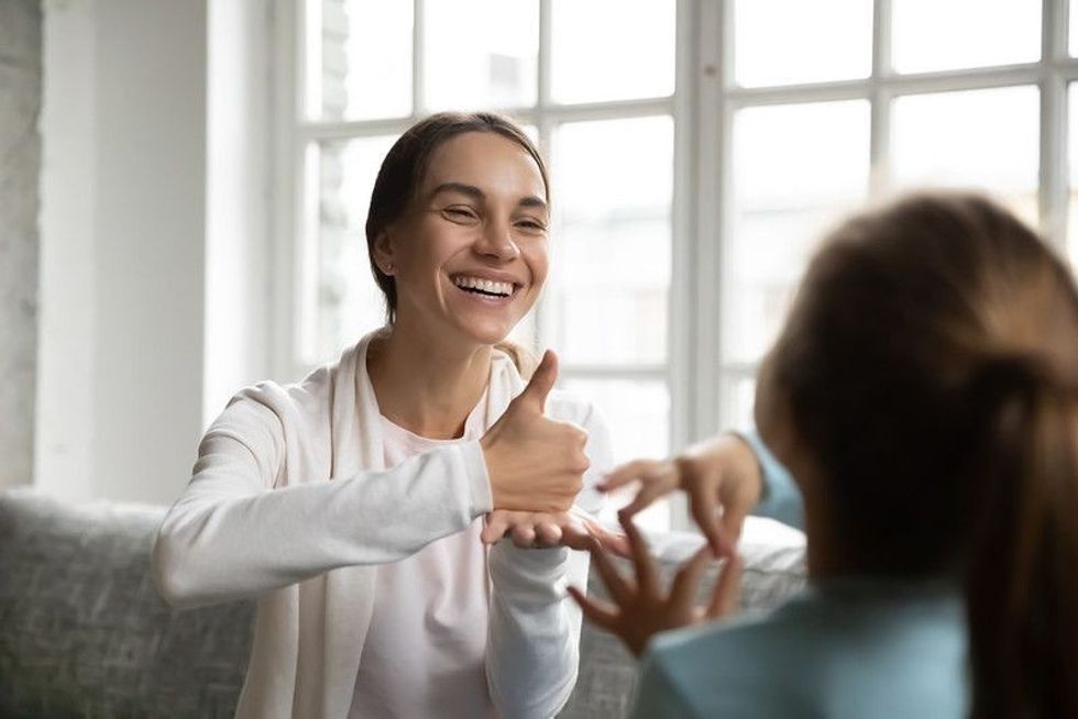 A woman making a conversation with sign language