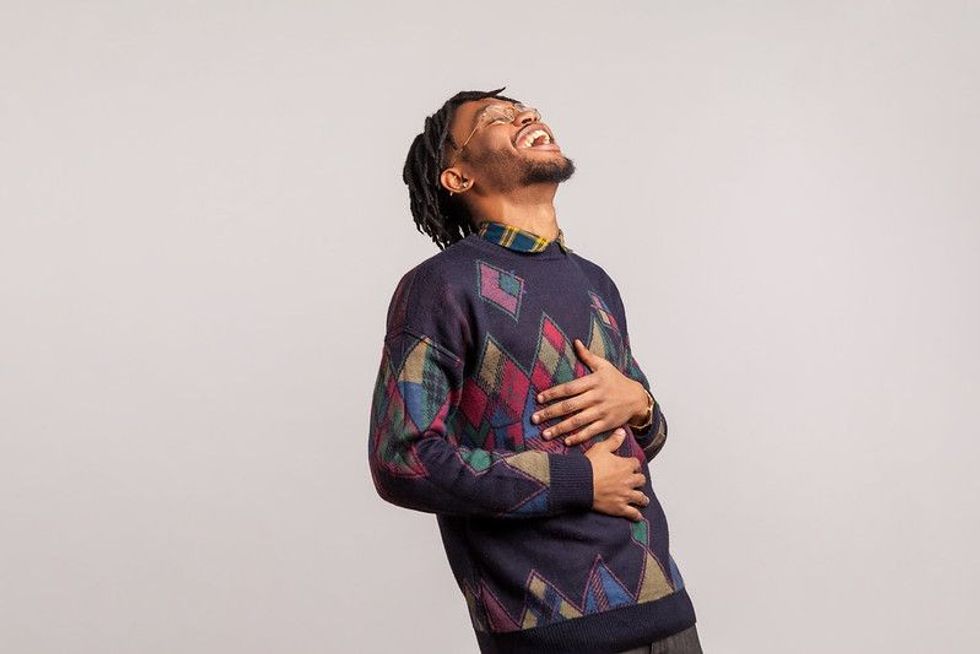 A young man having a good belly laugh