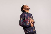 A young man having a good belly laugh