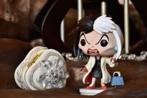 Action figure of Disney villain Cruella de Vil from animated film 101 Dalmatians.