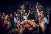 Actors at the London Bridge Experience entertaining the audience with a gruesome sliced open body on display.