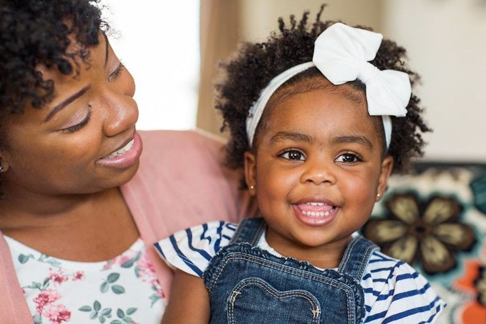 African ethnic mother and daughter laughing