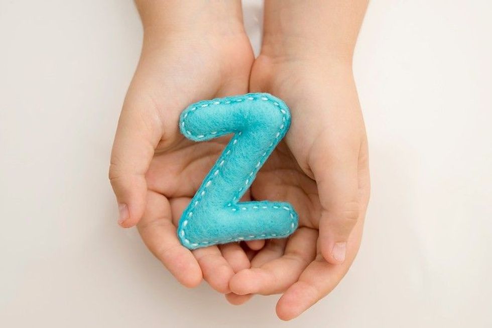 Alphabet Z in hands 