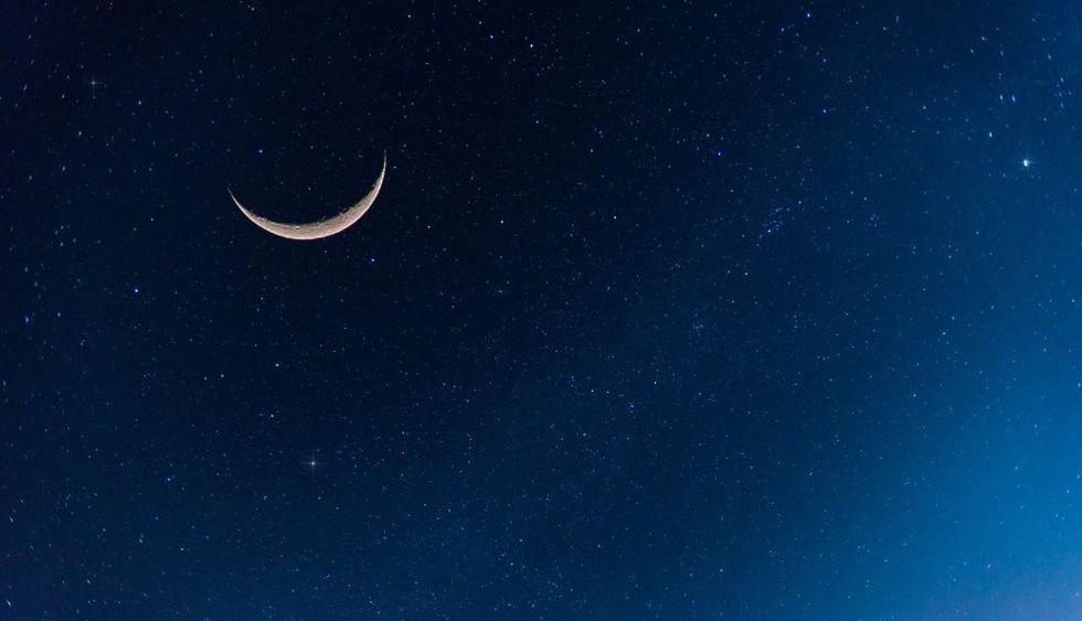 Amazing Crescent Moon on dark blue night sky background.