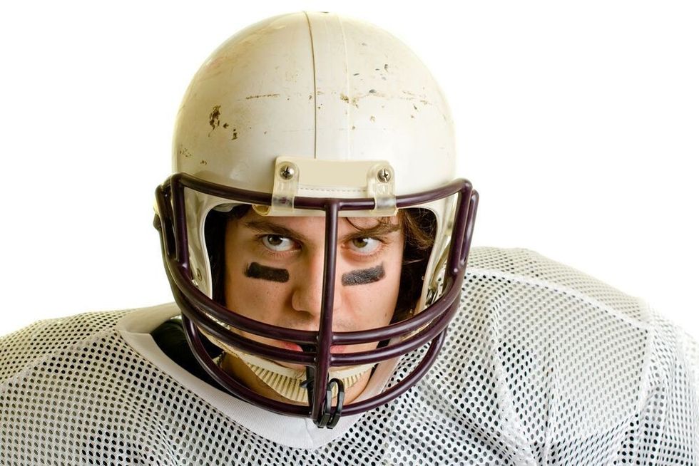 American football player. Headshot through facemask.
