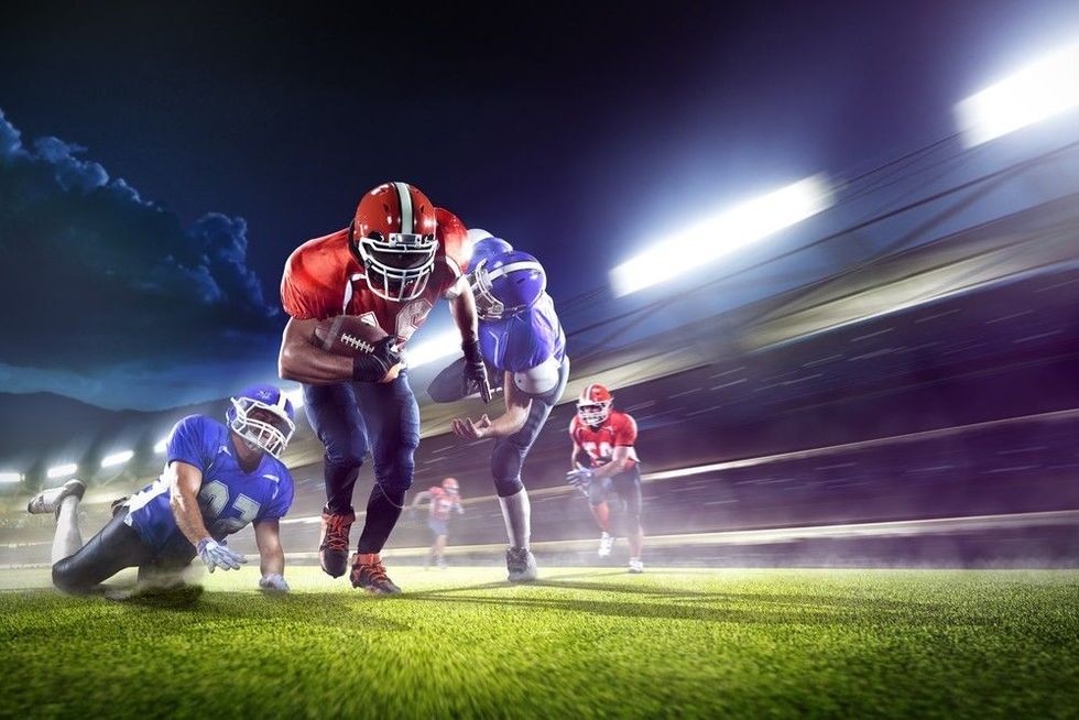 American football players in the action grand arena.