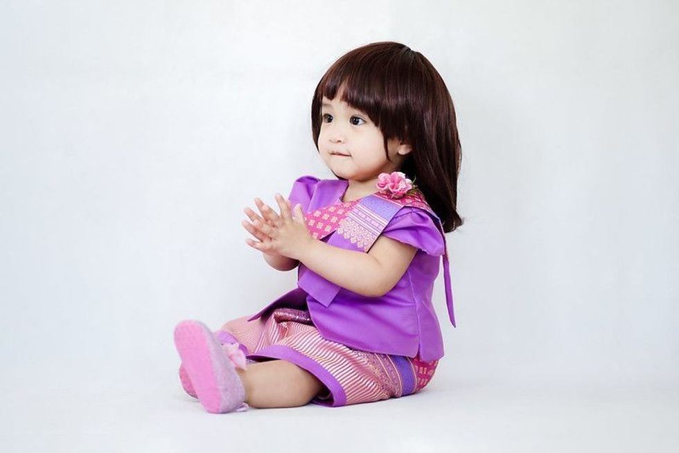 An adorable baby girl in Thai traditional costume.