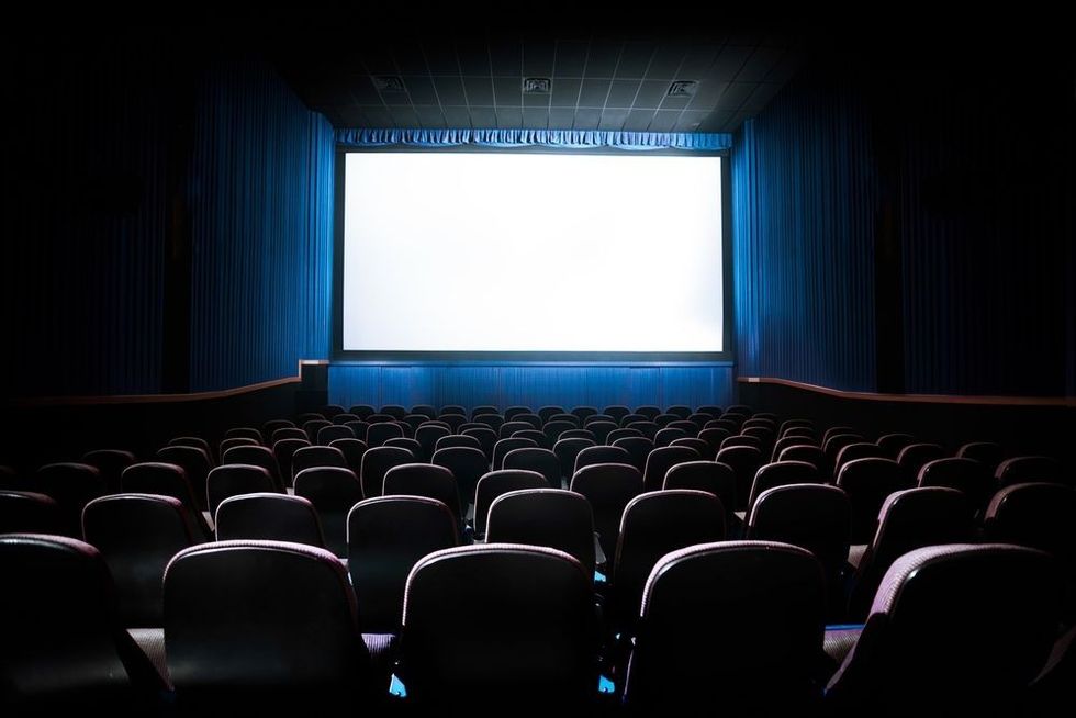An empty theater with red seats