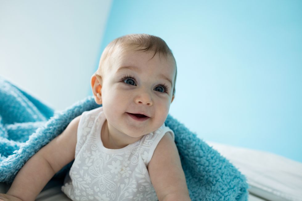An image of a baby girl smiling, capturing moments that inspire unique names for girls.