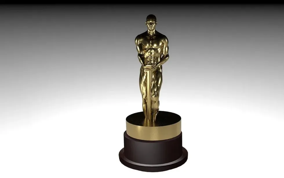 An Oscar award against a plain background, ideal for discussions around Oscar trivia and cinematic achievements.