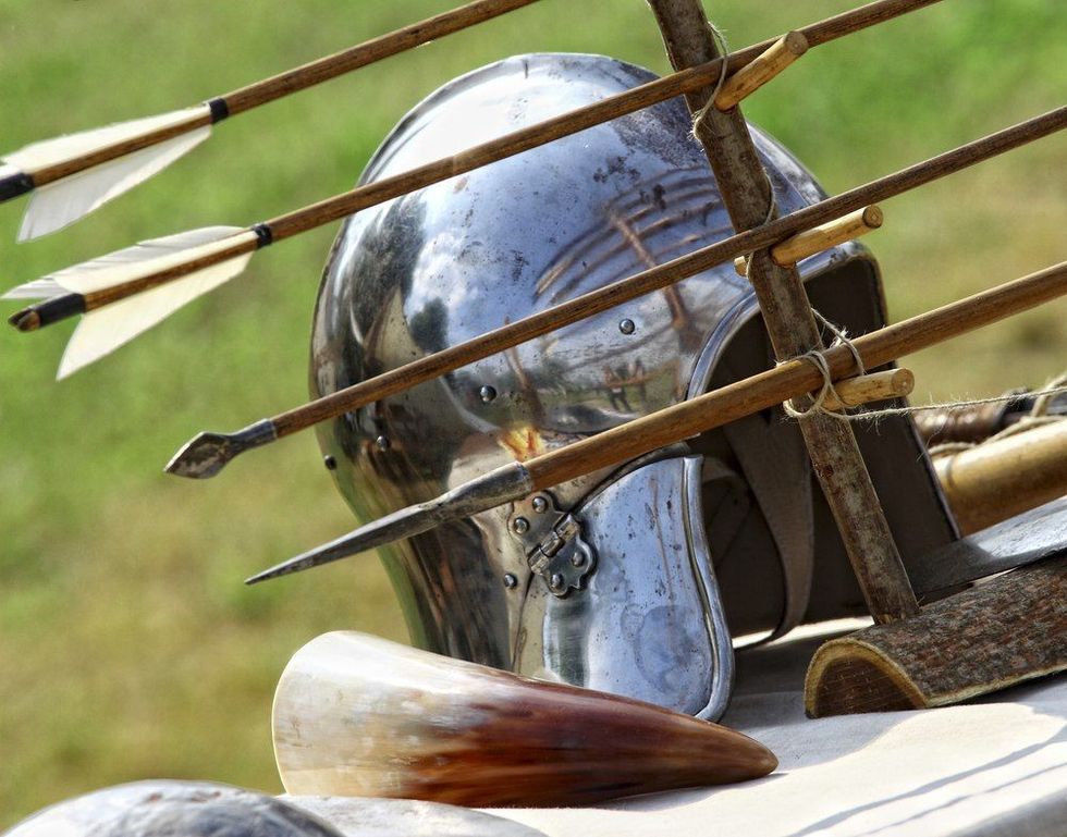 Ancient metal helmet and arrows