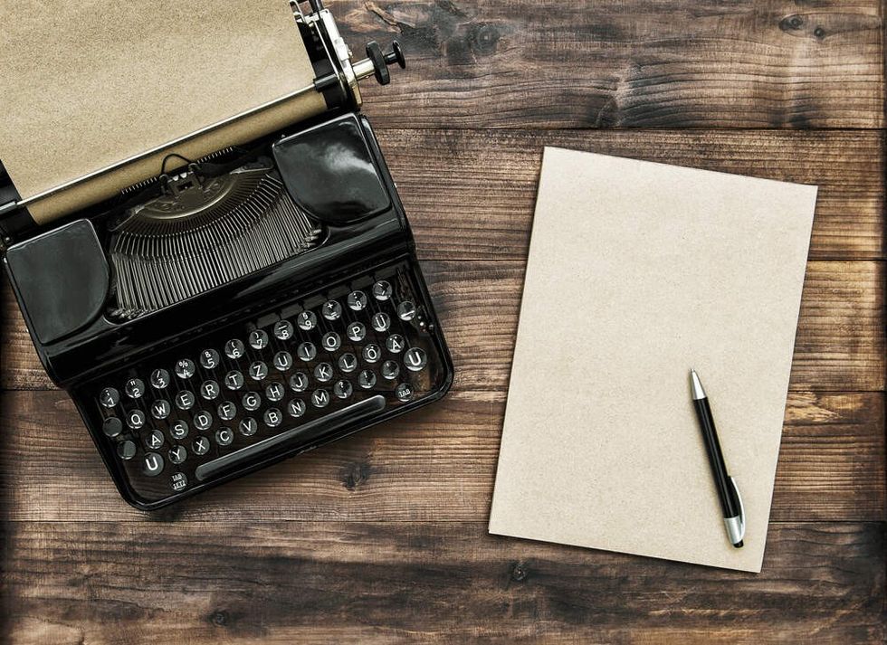 Antique typewriter with paper note book.