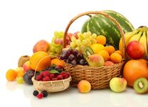 Assortment of exotic fruits and berries in baskets isolated on white