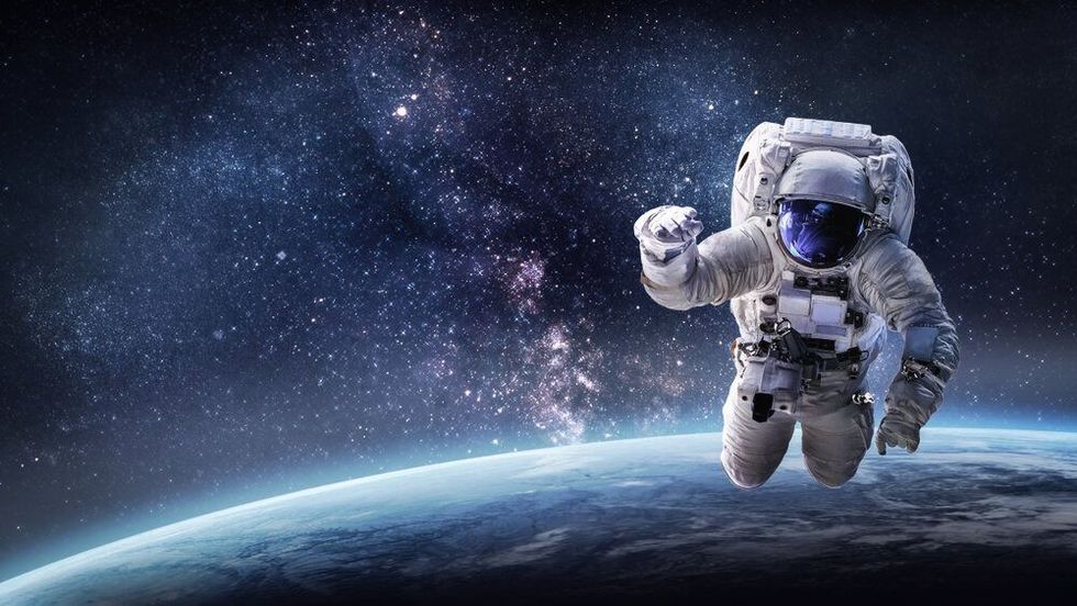 Astronaut in outer space over the planet Earth.