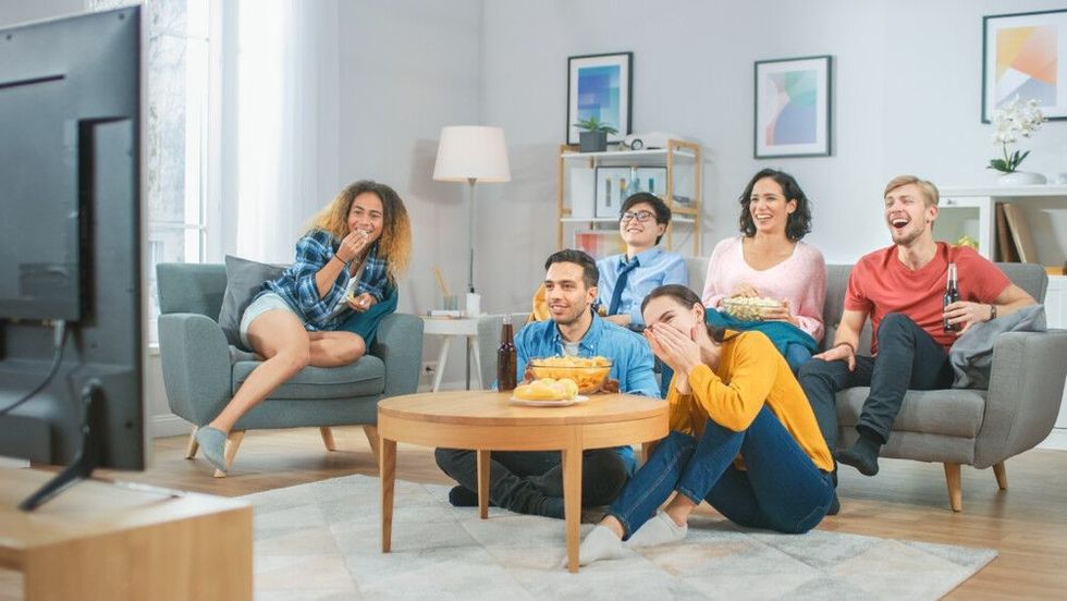 At Home Diverse Group Friends Watching TV Together