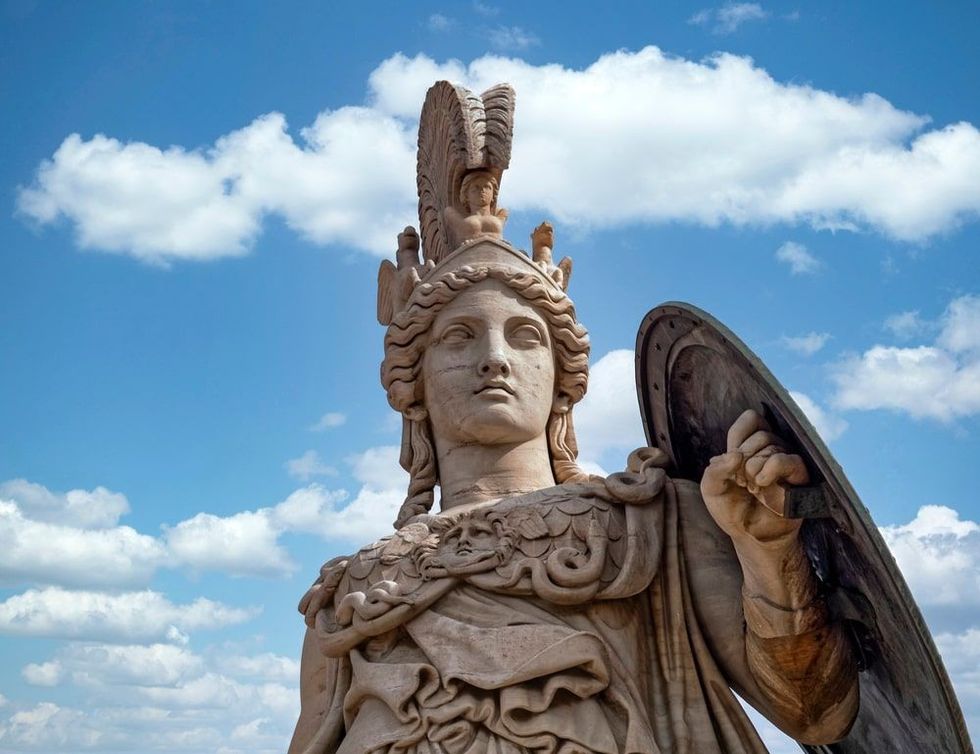Athena ancient Greek goddess statue and blue sky with some white clouds