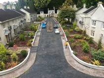 Babbacombe Model Village street with people and cars on it.